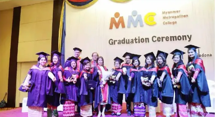 Graduating students in caps and gowns at the Myanmar Metropolitan College graduation ceremony