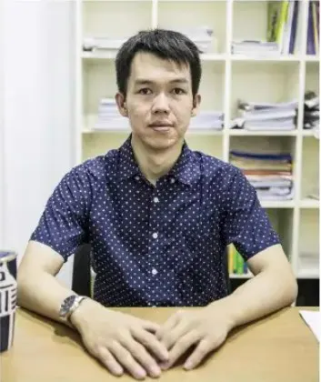 U Ye Thiha Thant, founder and CEO of Kings International School, seated at a desk in his office