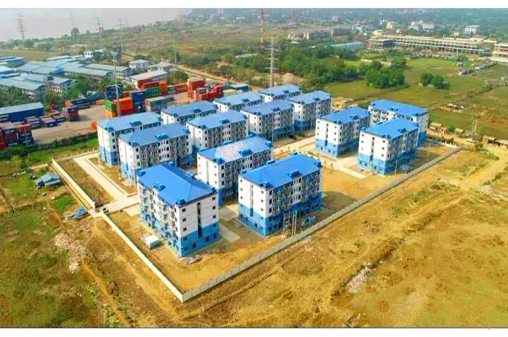 Aerial view of a low-cost housing estate with blue-roofed apartment blocks