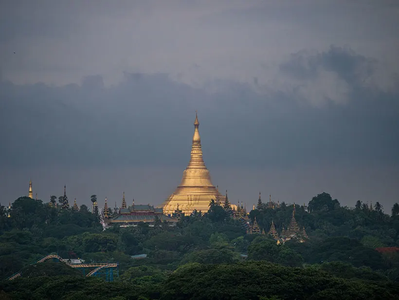 Shwedagon Pagoda rising above the tree line in Yangon